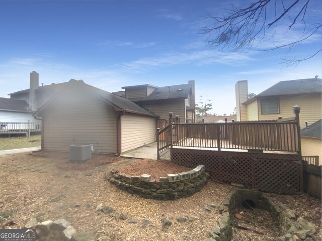 back of property featuring a wooden deck and central air condition unit