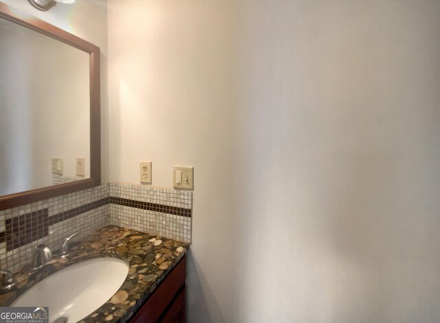 bathroom featuring tasteful backsplash and vanity