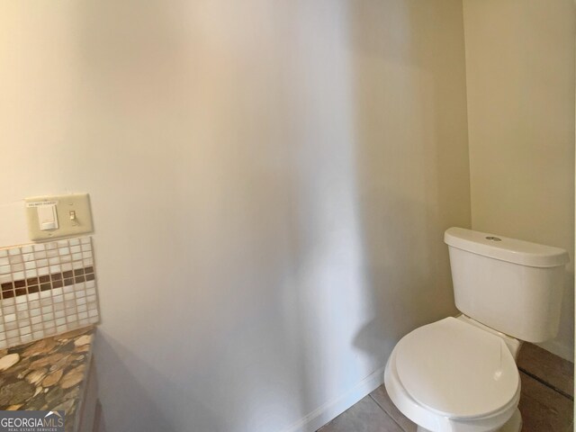 bathroom with tile patterned floors and toilet