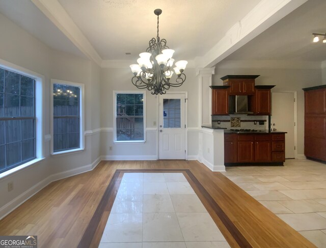 interior space featuring light tile patterned floors and a chandelier