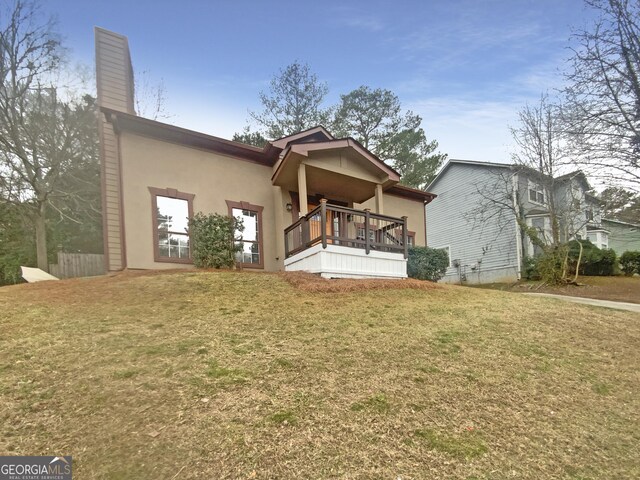 back of property featuring a lawn