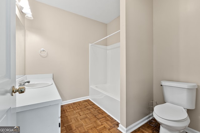 bathroom featuring vanity, parquet floors, and toilet