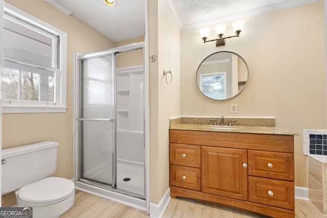 bathroom featuring a shower with door, vanity, wood-type flooring, a textured ceiling, and toilet