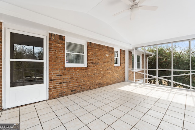 unfurnished sunroom featuring lofted ceiling and ceiling fan