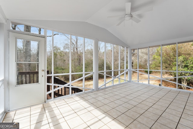 unfurnished sunroom featuring ceiling fan and vaulted ceiling