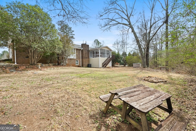 view of yard featuring a sunroom