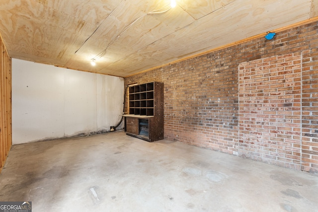 basement featuring brick wall