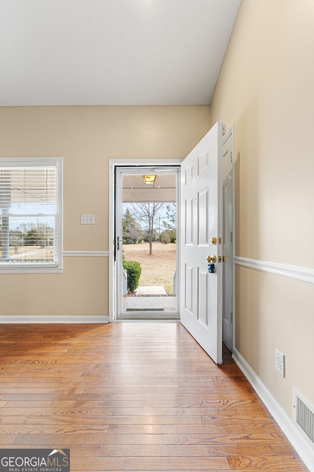 foyer entrance with light hardwood / wood-style flooring