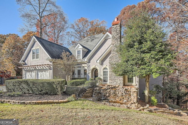 view of front of house featuring a garage and a front lawn