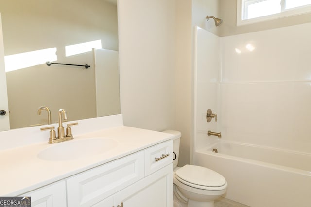 bathroom with toilet, washtub / shower combination, and vanity