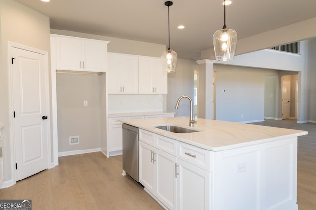 kitchen featuring visible vents, a sink, light wood-style flooring, and dishwasher