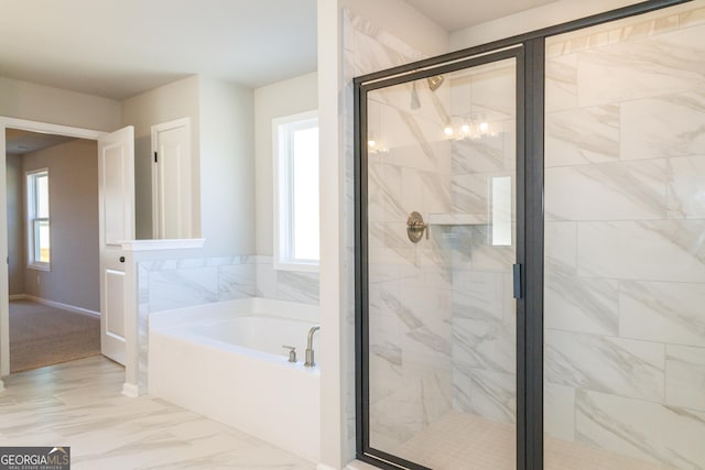 full bath with a stall shower, marble finish floor, and a garden tub