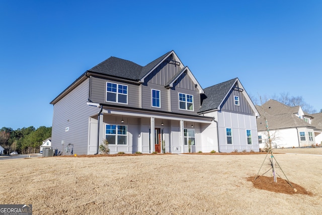 view of front of property featuring covered porch, a shingled roof, and board and batten siding