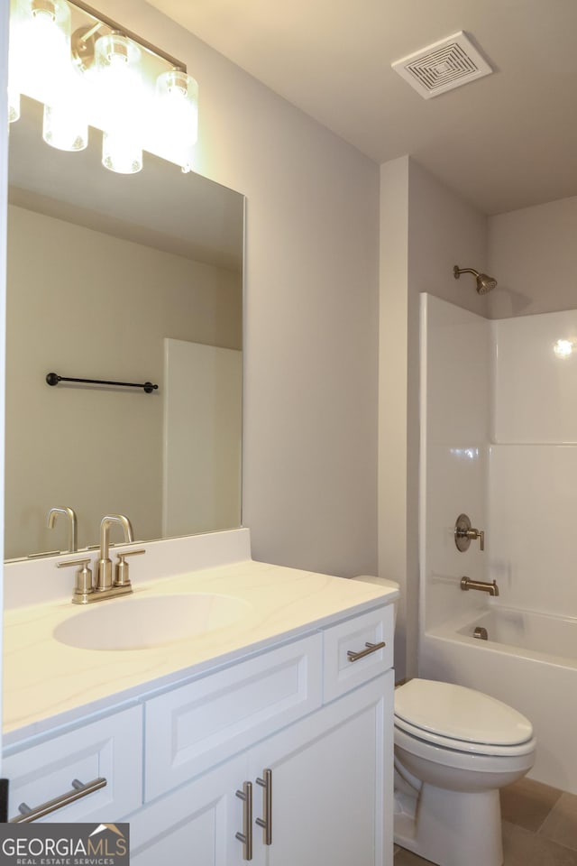 bathroom featuring visible vents, vanity, toilet, and bathing tub / shower combination