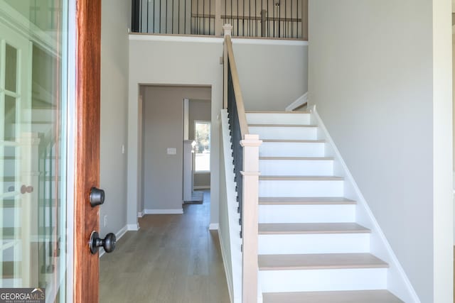 stairway featuring baseboards and wood finished floors