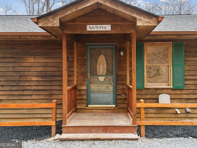 entrance to property with a shingled roof