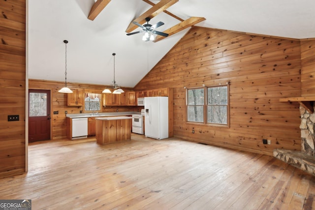 kitchen featuring a kitchen island, pendant lighting, white appliances, plenty of natural light, and light wood-type flooring