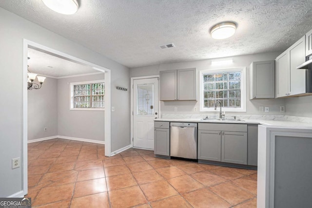 kitchen featuring light tile patterned flooring, dishwasher, sink, and gray cabinetry