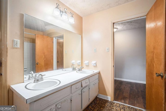 bathroom featuring vanity and a textured ceiling