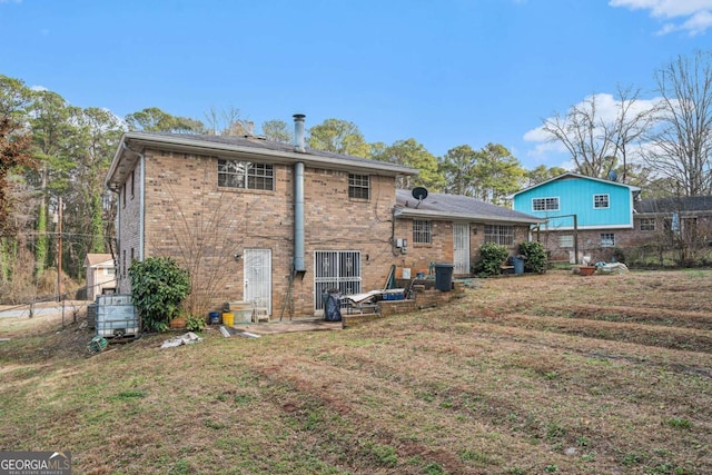 back of property with a patio and a yard