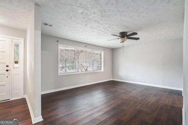 foyer with ceiling fan, a textured ceiling, and dark hardwood / wood-style flooring