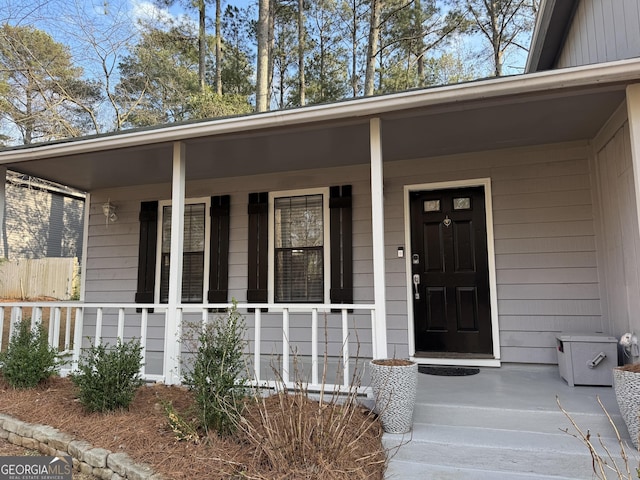 view of exterior entry with covered porch