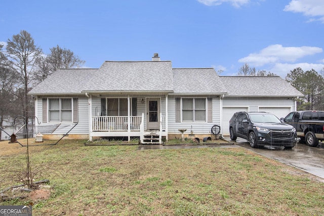 view of front of home with driveway, a front yard, an attached garage, and covered porch