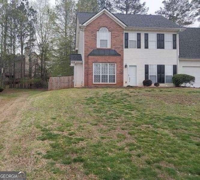 view of front of home featuring a garage and a front lawn