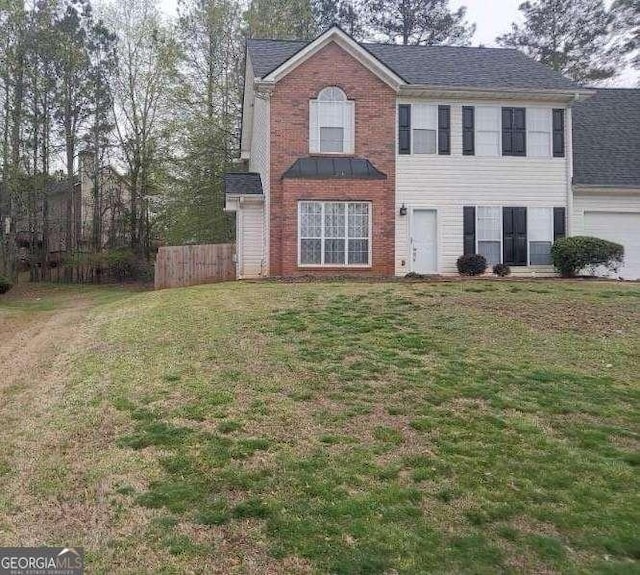 view of front of property with a garage and a front yard