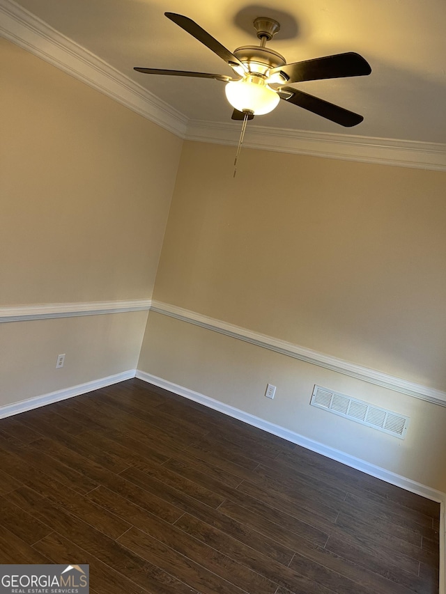 empty room featuring dark wood-type flooring, ceiling fan, and crown molding