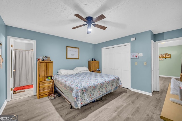 bedroom with light hardwood / wood-style floors, a closet, and a textured ceiling