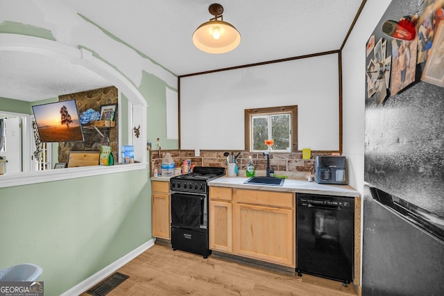 kitchen with sink, black appliances, light hardwood / wood-style flooring, light brown cabinets, and backsplash