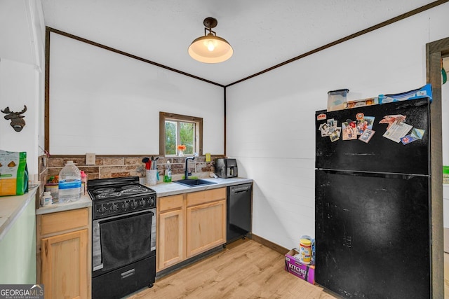 kitchen with sink, crown molding, light brown cabinets, light hardwood / wood-style floors, and black appliances