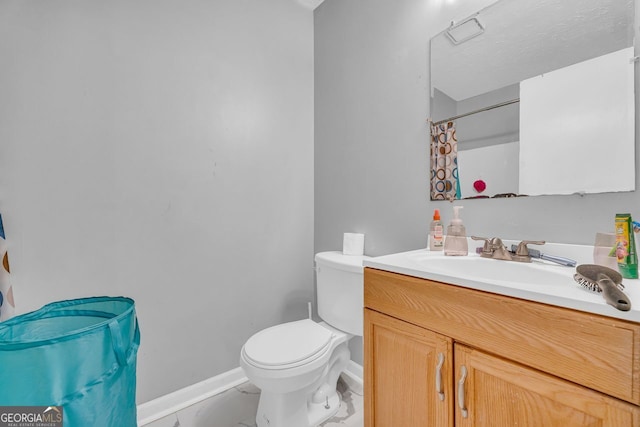 bathroom featuring vanity, walk in shower, and toilet