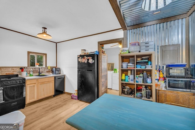 kitchen with separate washer and dryer, sink, black appliances, light brown cabinets, and light hardwood / wood-style flooring