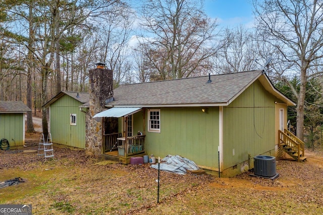 back of house with central AC unit