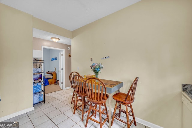 dining area with light tile patterned floors