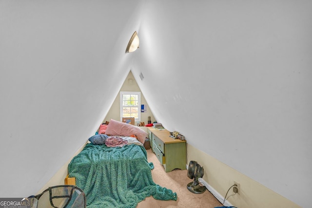 carpeted bedroom featuring lofted ceiling