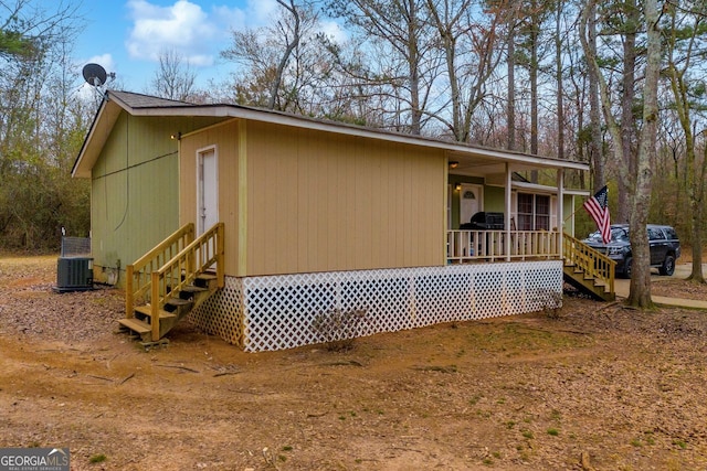 view of side of home with covered porch