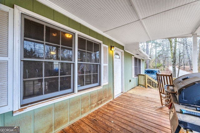 wooden terrace featuring grilling area