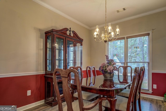 dining area featuring a notable chandelier, crown molding, and dark hardwood / wood-style floors