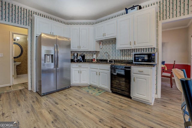 kitchen with white cabinetry, sink, ornamental molding, stainless steel appliances, and light wood-type flooring