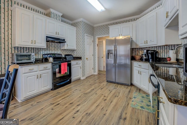 kitchen featuring sink, white cabinetry, electric range, stainless steel fridge, and dark stone counters