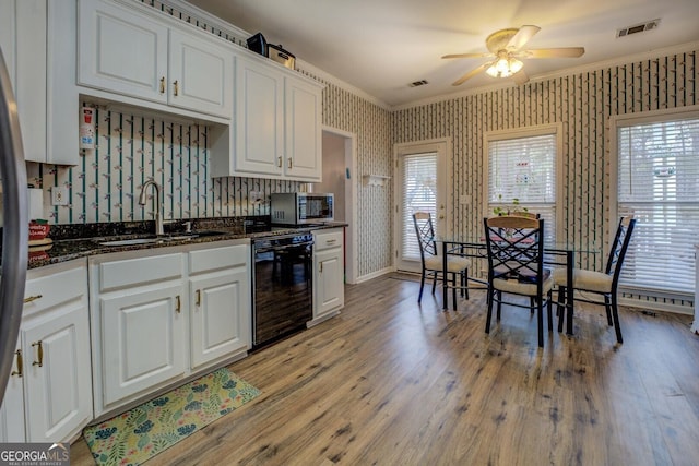 kitchen featuring sink, light hardwood / wood-style flooring, ornamental molding, dishwasher, and white cabinets