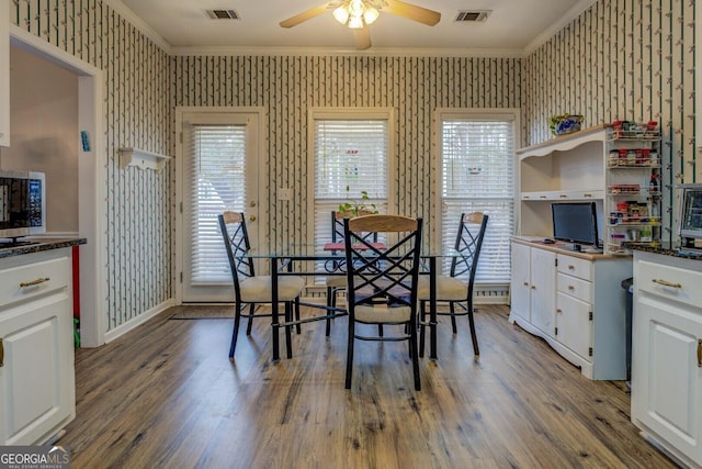 dining area featuring crown molding, wood-type flooring, and ceiling fan