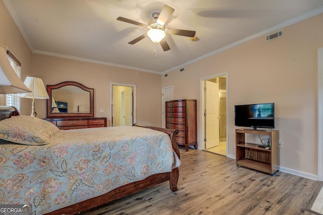 bedroom with ornamental molding, ceiling fan, and light wood-type flooring