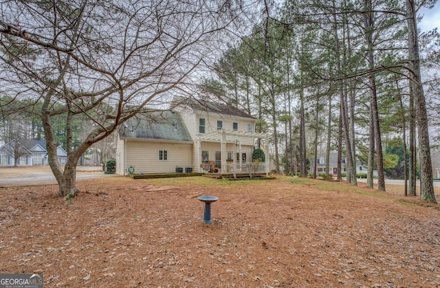 view of front of house with a wooden deck and a pergola