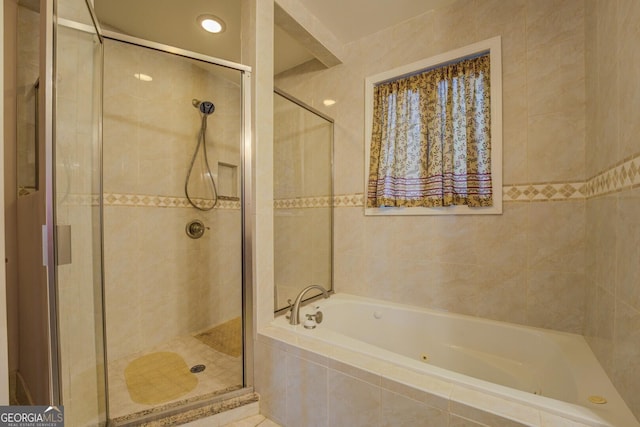 bathroom with tile walls and plus walk in shower