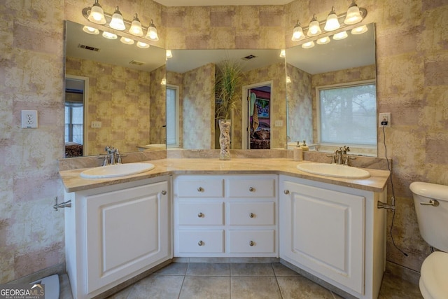 bathroom featuring vanity, tile patterned flooring, and toilet