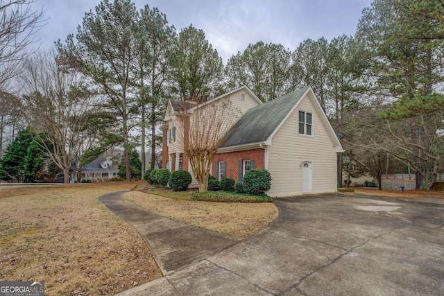 view of property exterior with a lawn